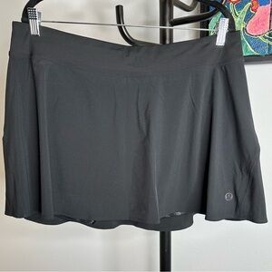 Lululemon light weight high rise tennis skirt in black. Size 14. NWT.